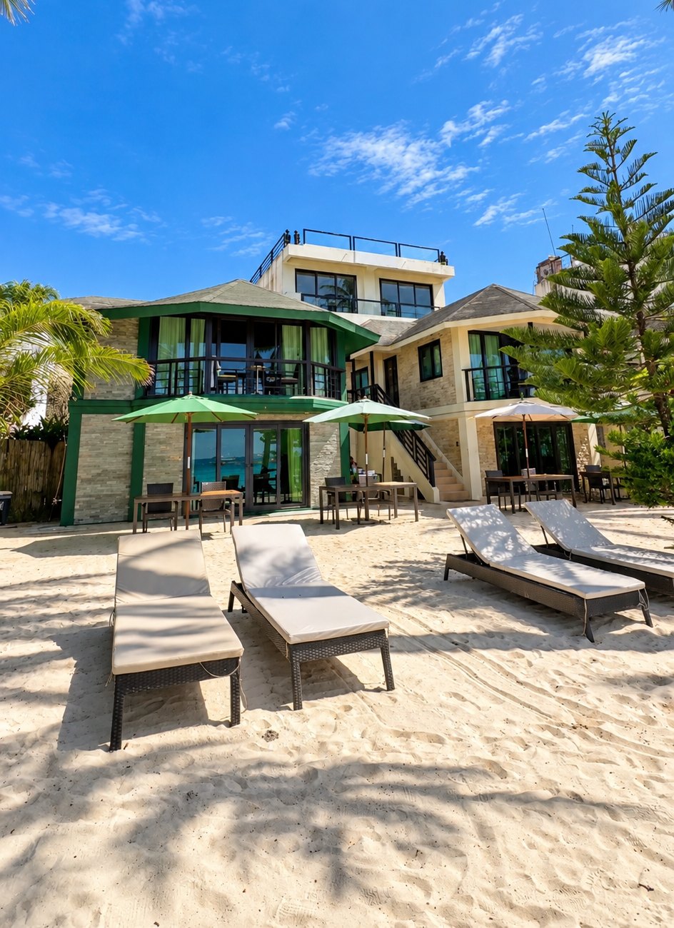 Boracay Beach Houses on the beachfront with sun loungers and palm trees